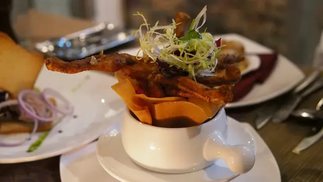 Sautéed Frog Leg with Garlic Herb Butter in Crispy Basket