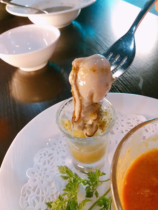 Crab Bisque accompanied by Oyster Shooter