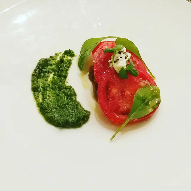 Japanese fruit tomato with imam bayildi, rocket pesto, sour cream and marfuga olive oil.
