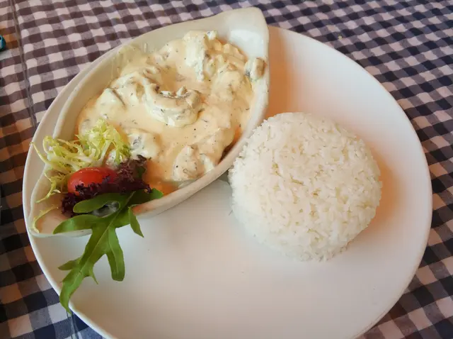 Chicken strips in cream garlic goat cheese sauce with rice