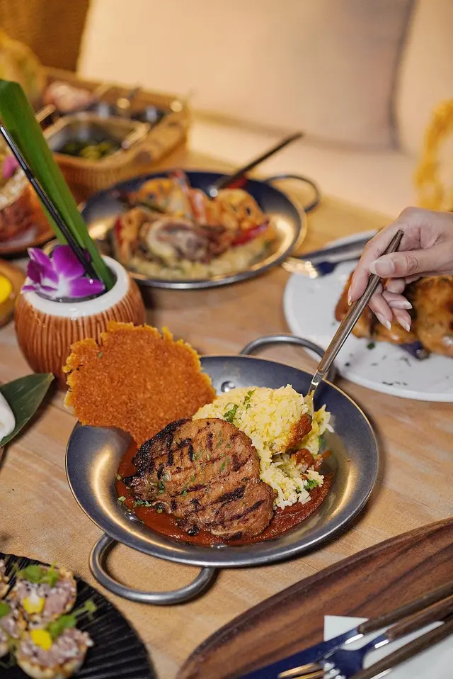 Golden Fried Rice Topped with Grilled Pork Chop and Spiced Tomato Gravy