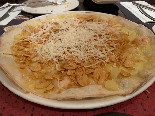 Mad for Garlic signature pizza topped with sweet garlic cloves, fried garlic, shrimps & diced pineapple