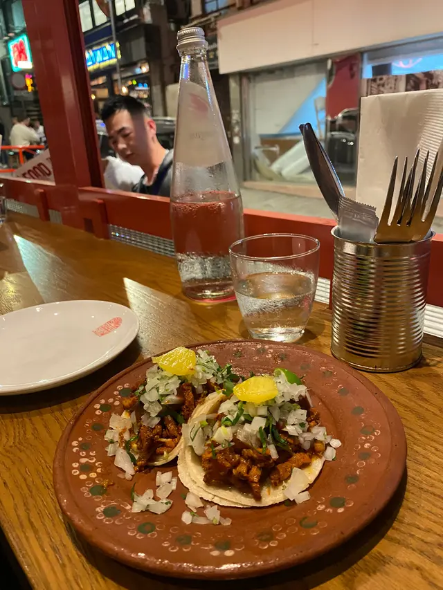 AI Pastor from the Trompo (A Mexico City staple; slices of achiote-marinated pork with salsa roja, onions, coriander, charred pineapple)