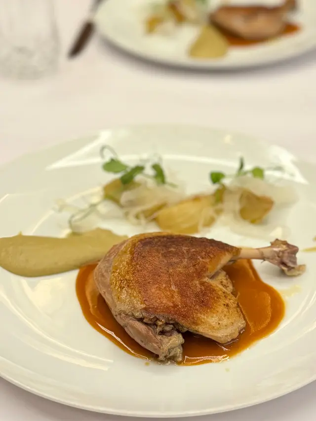 Duck leg confit, three way of fennel, orange sauce, and cumin seed
