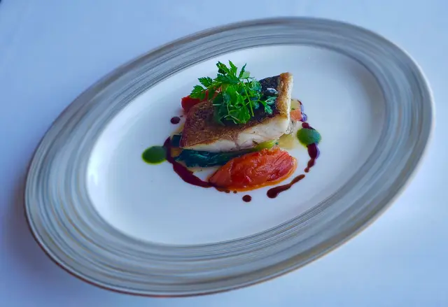 Main course - Sustainable Mediterranean Sea Bass with Piperade and Black Grape Sauce 
